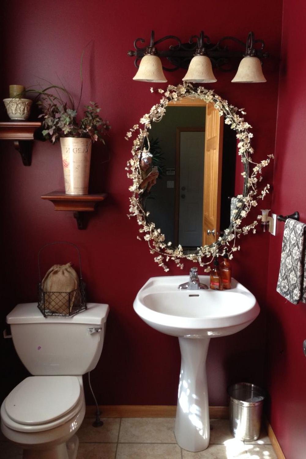 A warm and inviting dark red bathroom with modern fixtures and stylish shelving.