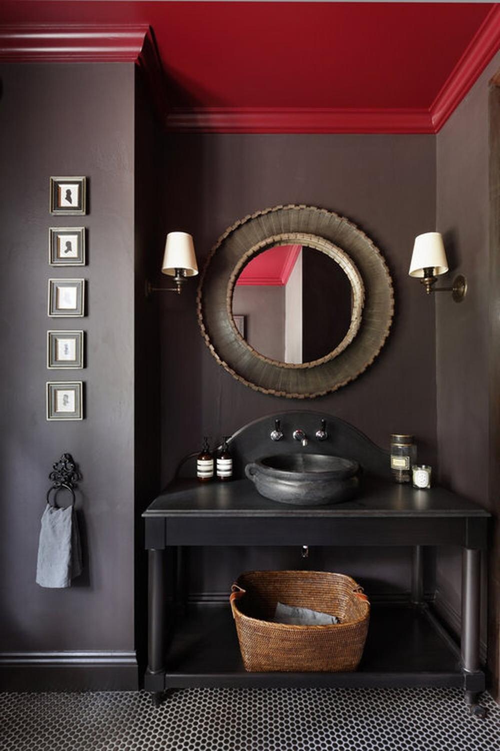A stylish modern bathroom featuring dark colors and elegant fixtures.