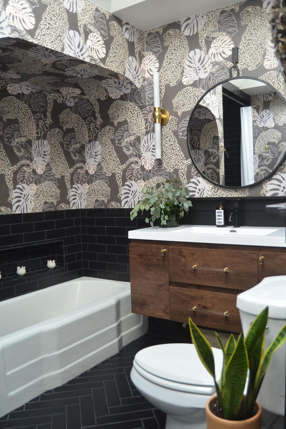 Bathroom featuring dark wallpaper and rectangular bathtub