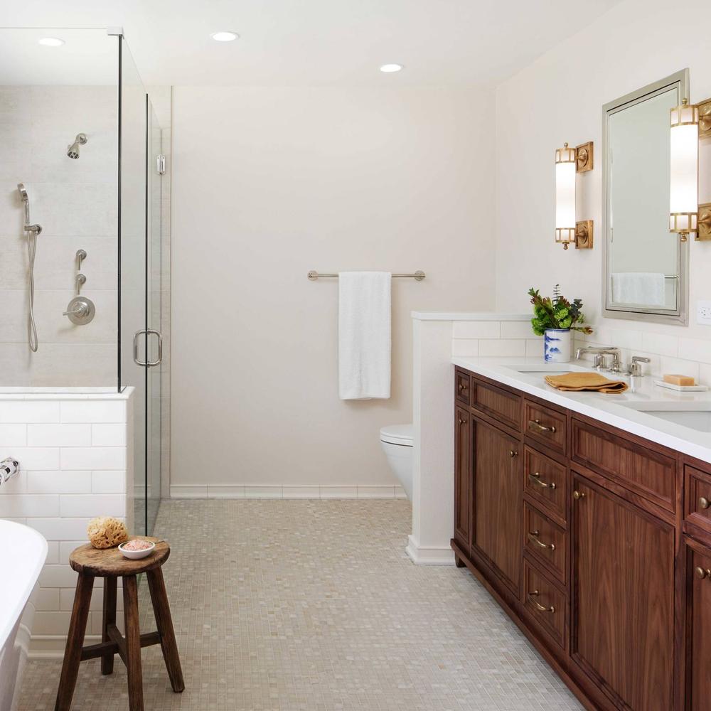 Contemporary dark wood bathroom vanity featuring dual sinks and modern details
