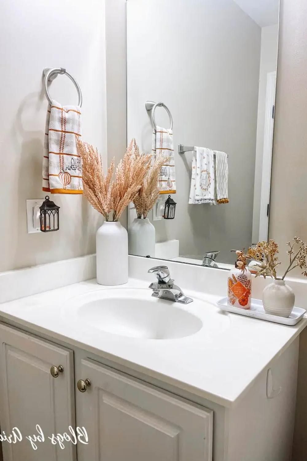 Personalized decorative elements in a fall-themed bathroom enhance the cozy ambiance.