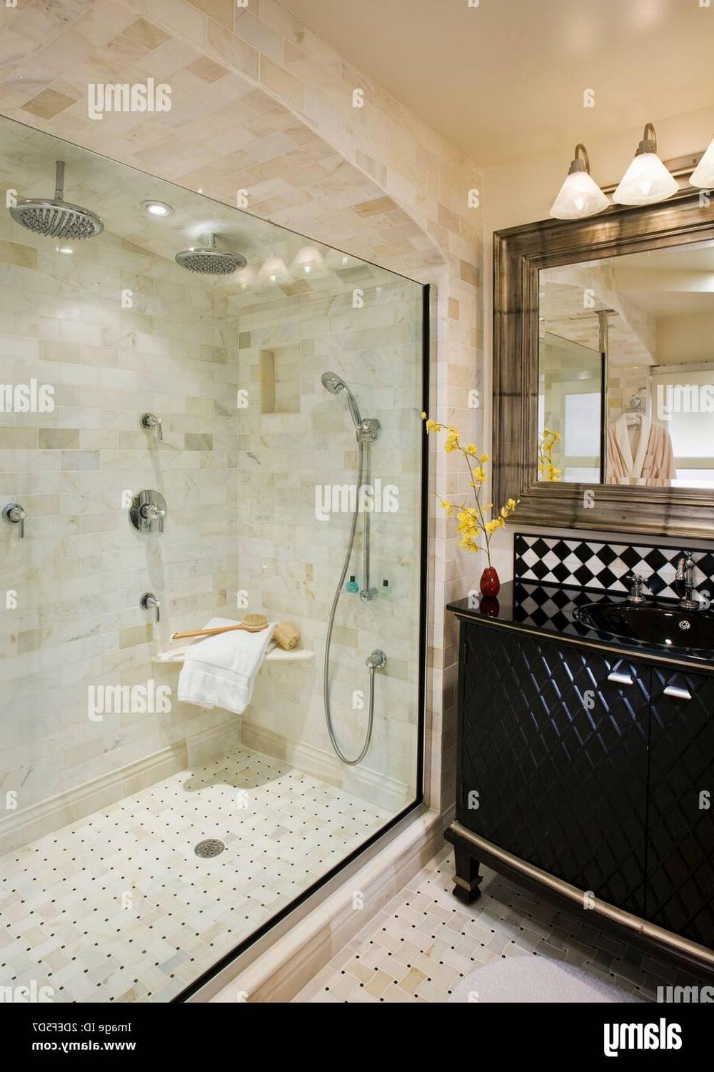 Luxurious double shower bathroom featuring built-in bench and quilted texture vanity.
