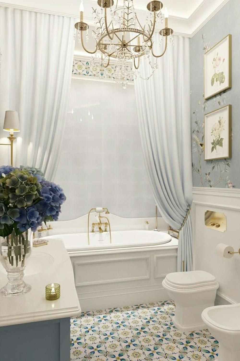 Elegant bathroom featuring sheer light blue double shower curtain setup, complementing a luxurious freestanding bathtub.