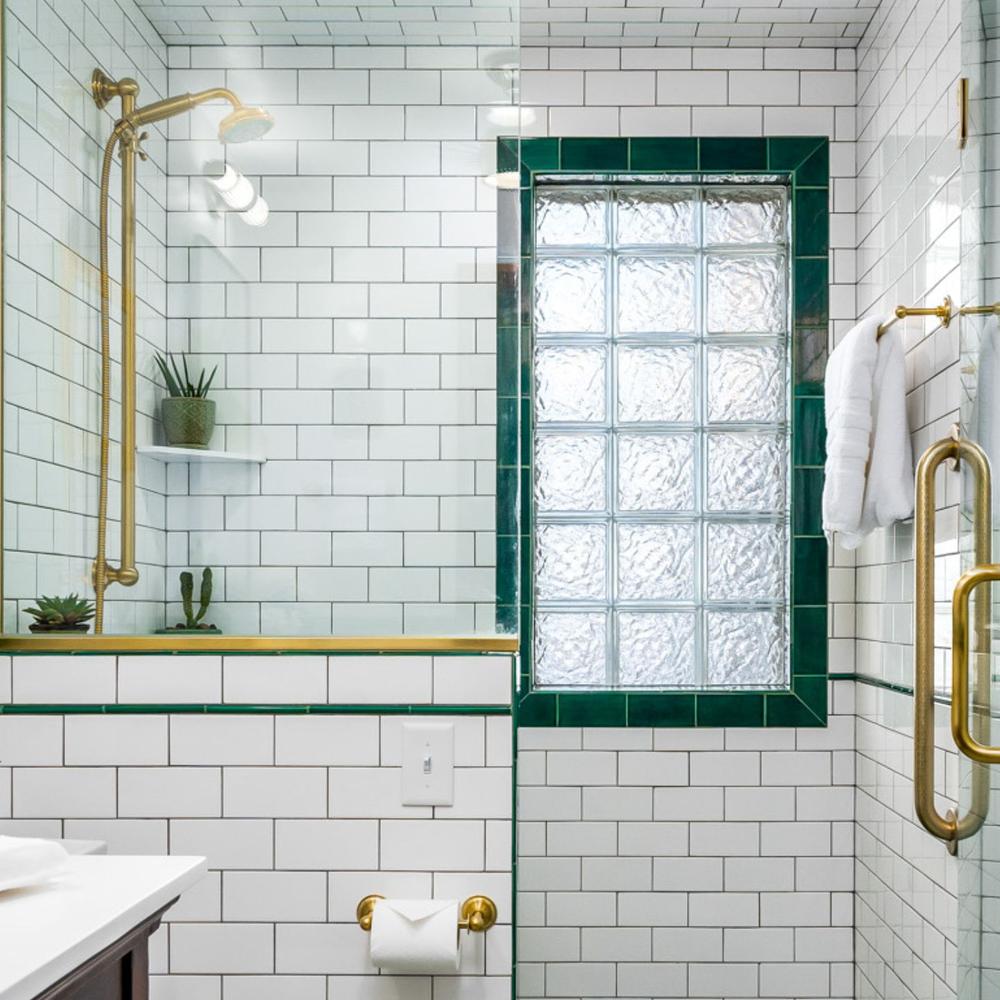A clean and bright bathroom with emerald green accents