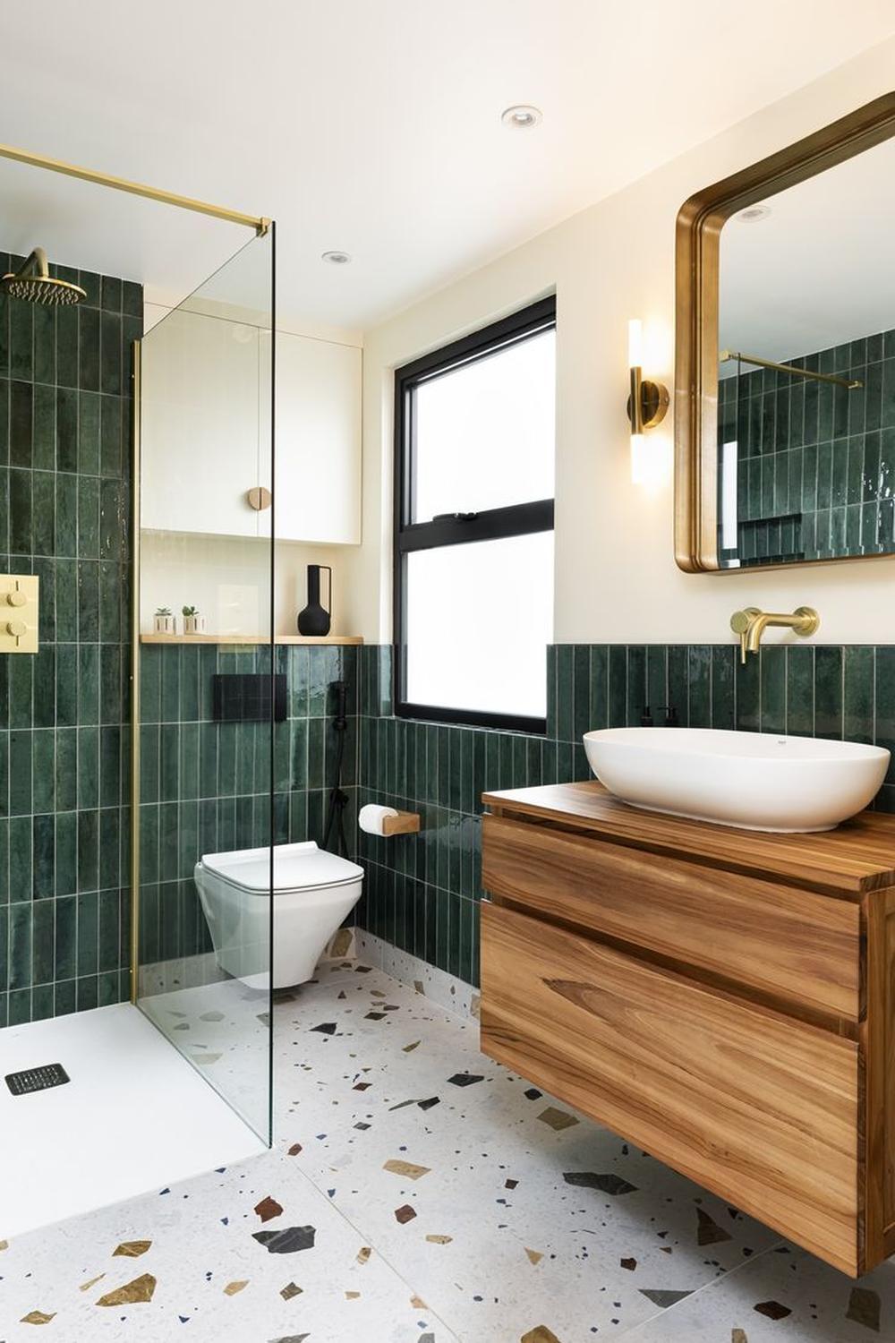 A stylish bathroom featuring contrasting textures with emerald green tiles