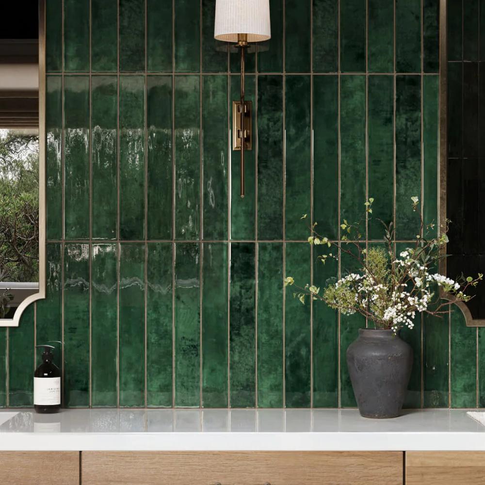 A luxurious bathroom featuring a stylish immersive emerald green environment