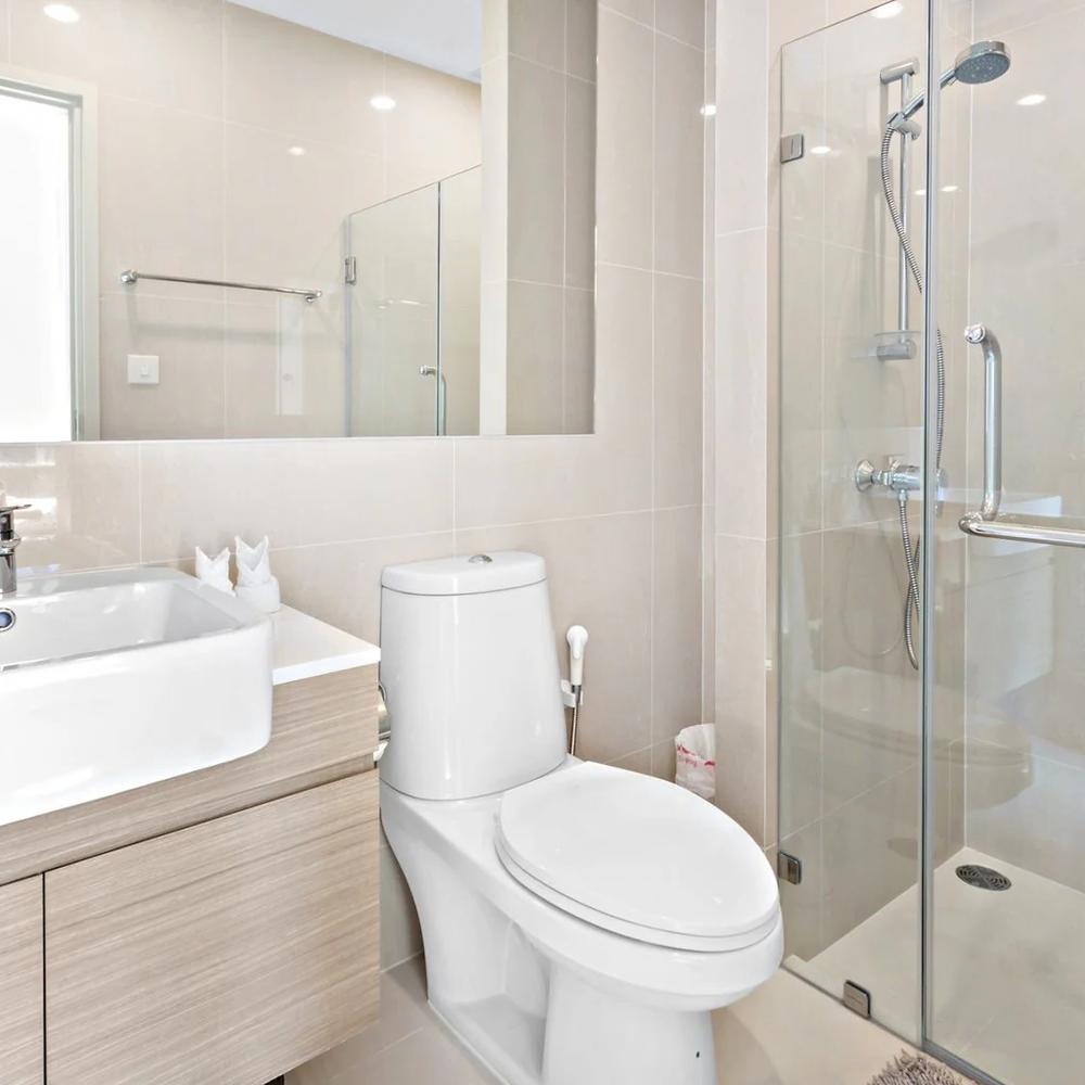 Coastal-inspired modern ensuite bathroom with light beige tones.