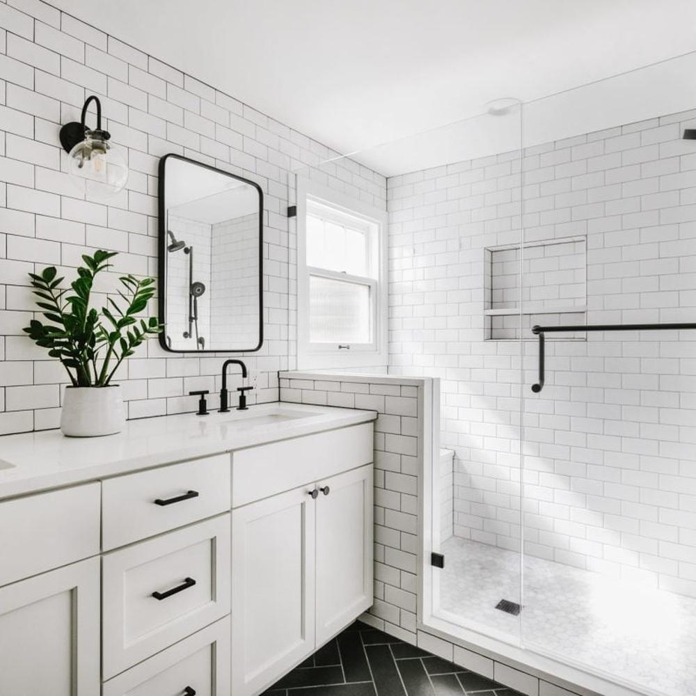 Stylish bathroom combining white shiplap and dark accents for a modern farmhouse look.