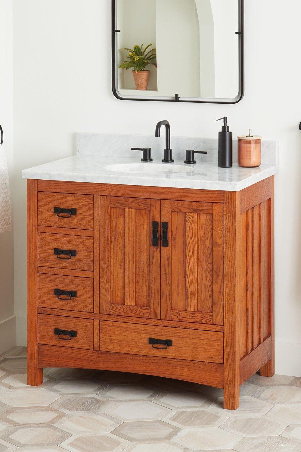 Striking black oval sink with rustic charm in farmhouse bathroom vanity