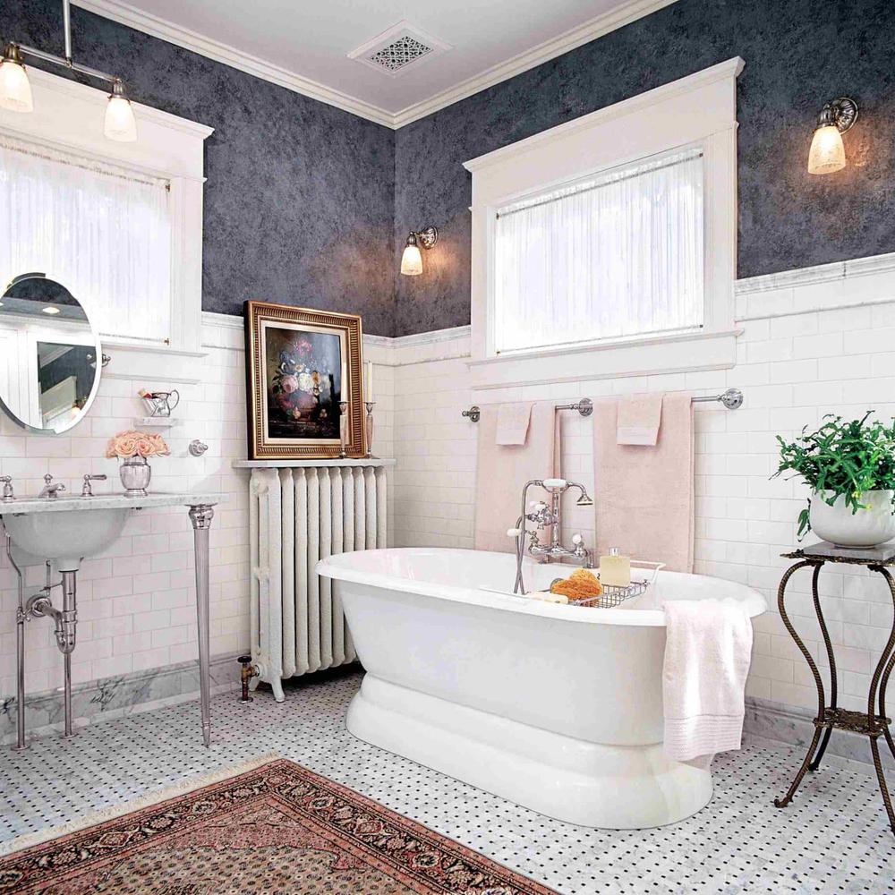 A classic feminine bathroom with dark blue walls, classic white bathtub, and elegant accents creating a serene retreat.