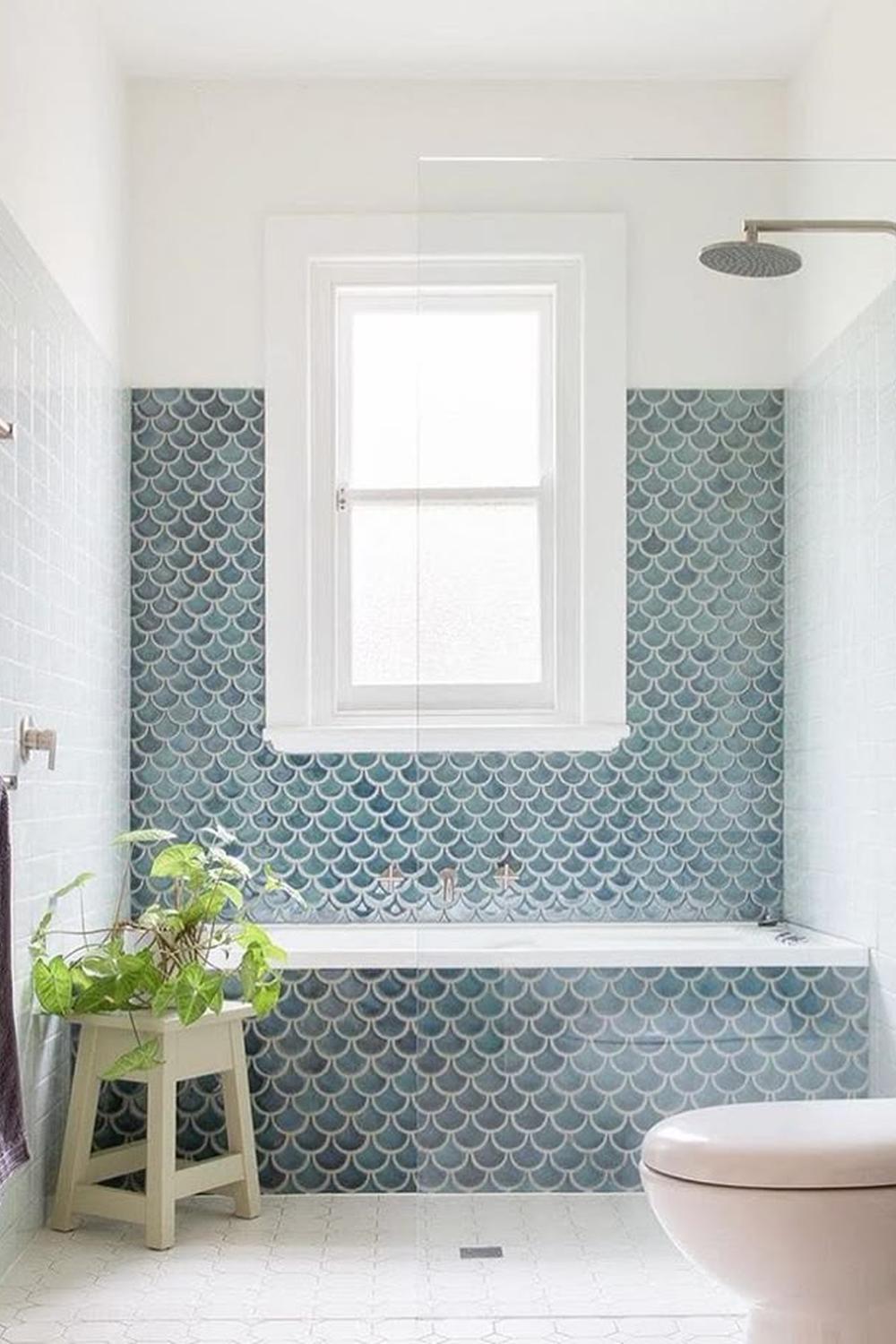 Bathroom design featuring fish scale tiles in blue and green hues