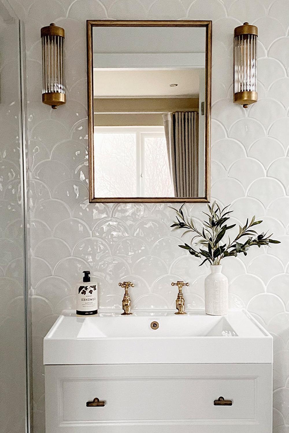 Elegant bathroom featuring white fish scale tile wall and modern vanity