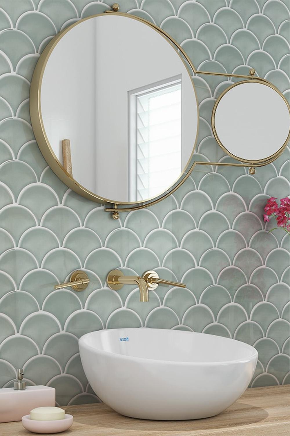 Stylish bathroom featuring green fish scale tiles and round mirrors