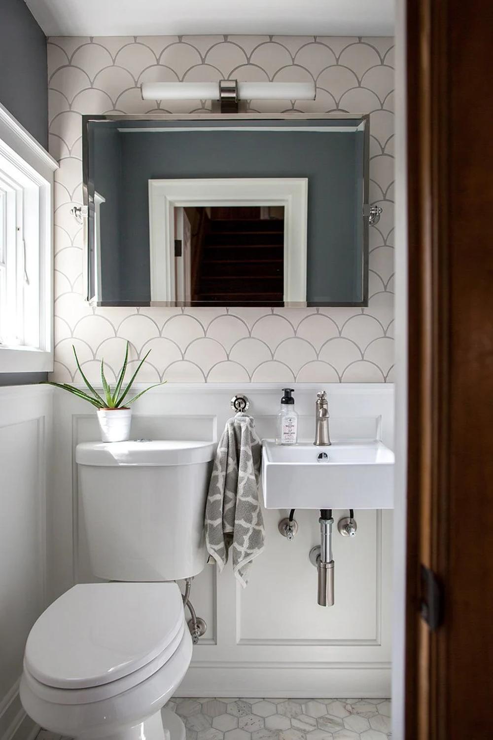 Contemporary bathroom featuring neutral fish scale tile design