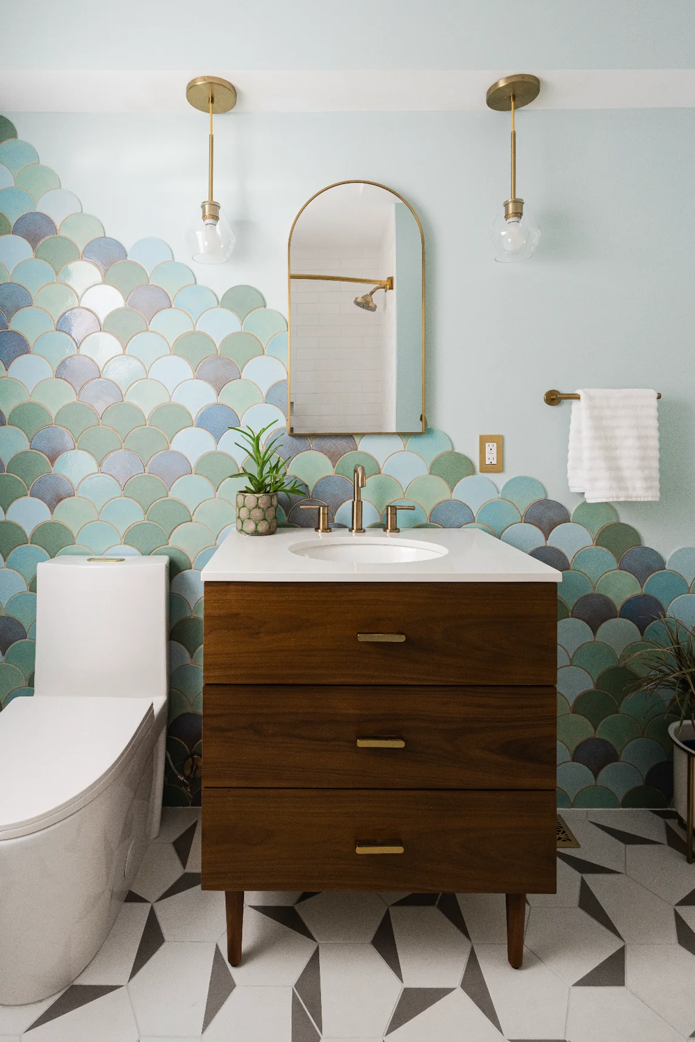 Bathroom design featuring earthy green fish scale tiles