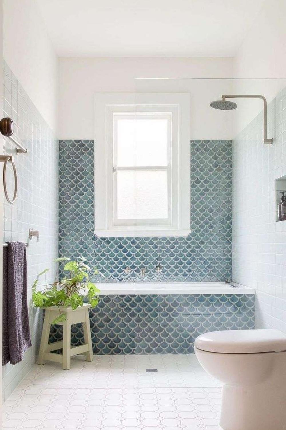 Stylish bathroom featuring aqua gradient fish scale tile design