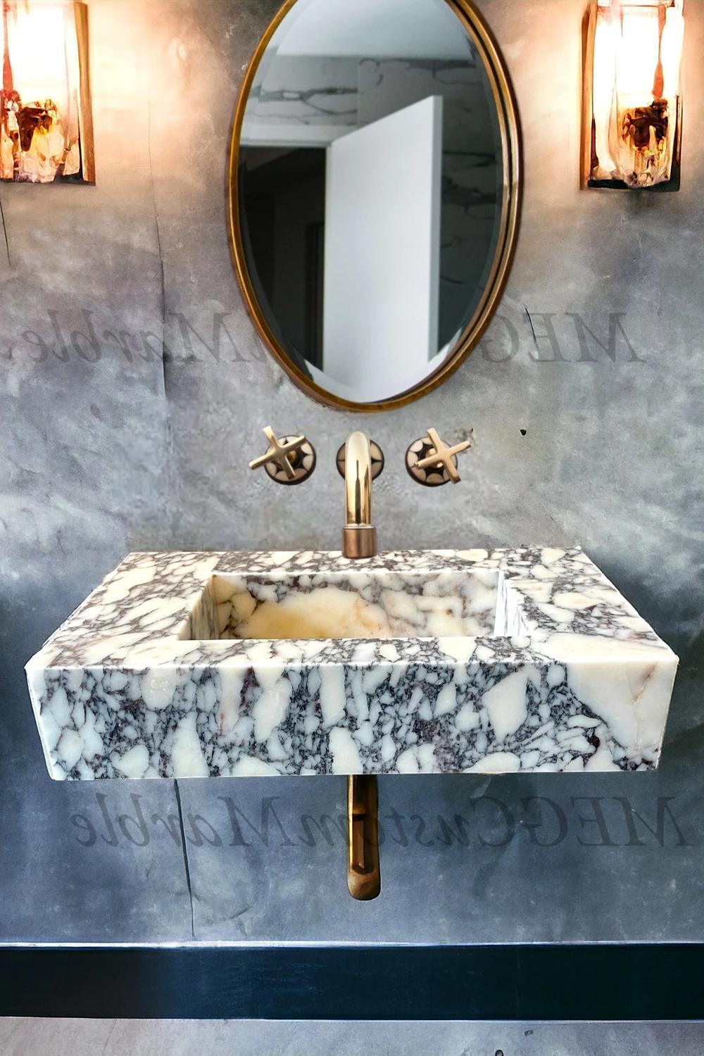 A stylish marble floating vanity showcasing bold speckled patterns of cream, gray, and burgundy, accompanied by bronze fixtures.
