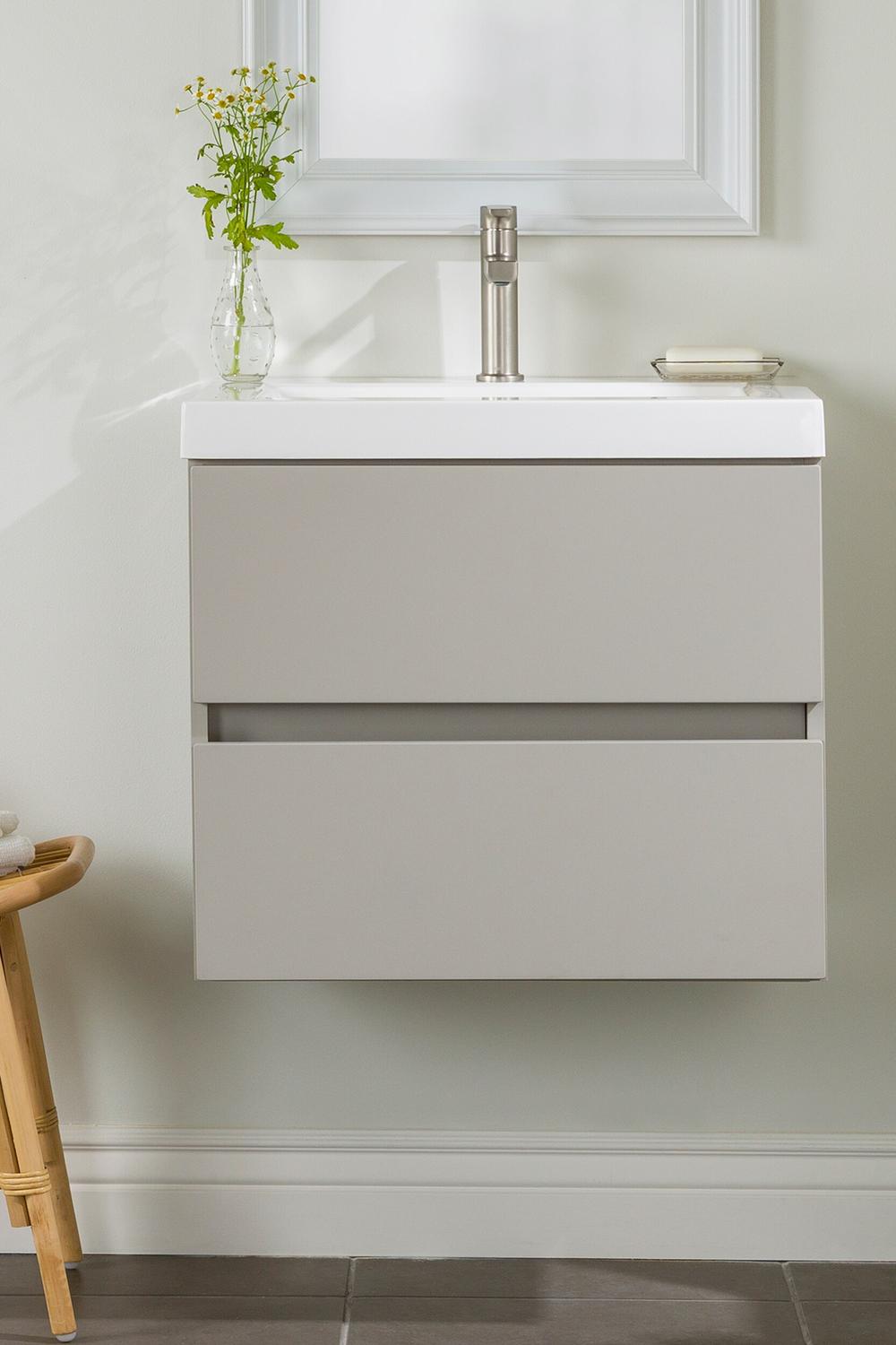 Minimalistic floating marble vanity with concealed handles and sleek lines, accentuating modern aesthetics.