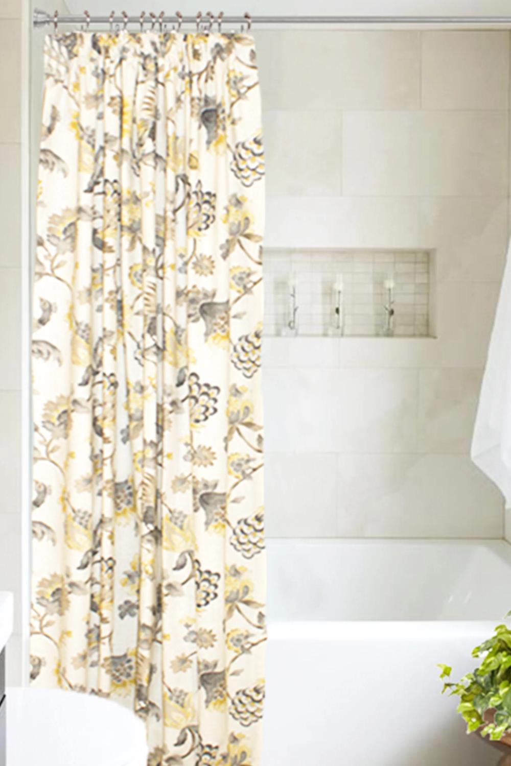 A breath of fresh floral air shower curtain adding lovely colors and patterns to a bright bathroom.