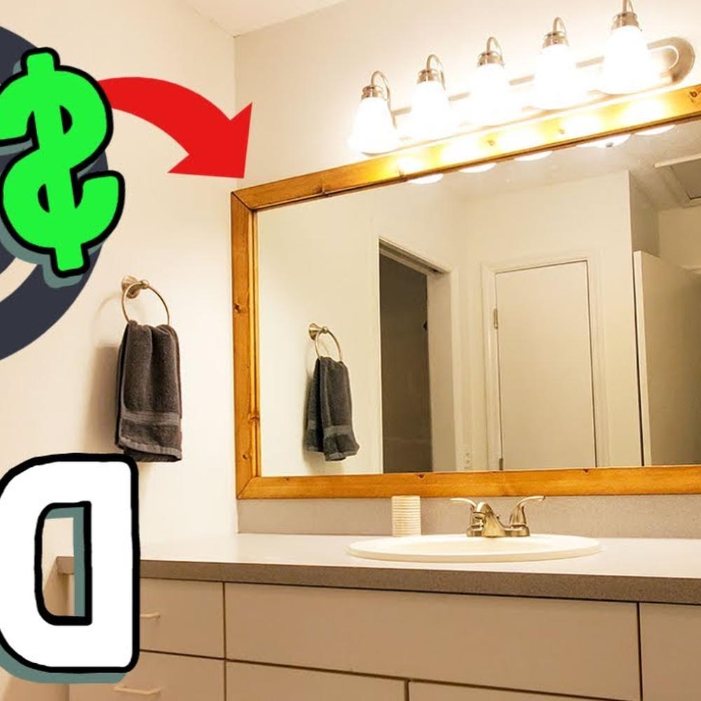 Rectangular mirror framed in warm wood surrounded by modern decor elements in a contemporary bathroom.