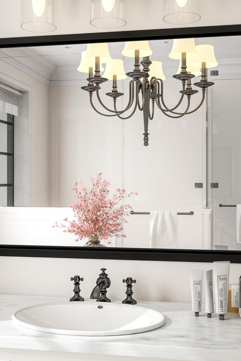 Stylish large framed mirror above a contemporary black-and-white sink vanity.