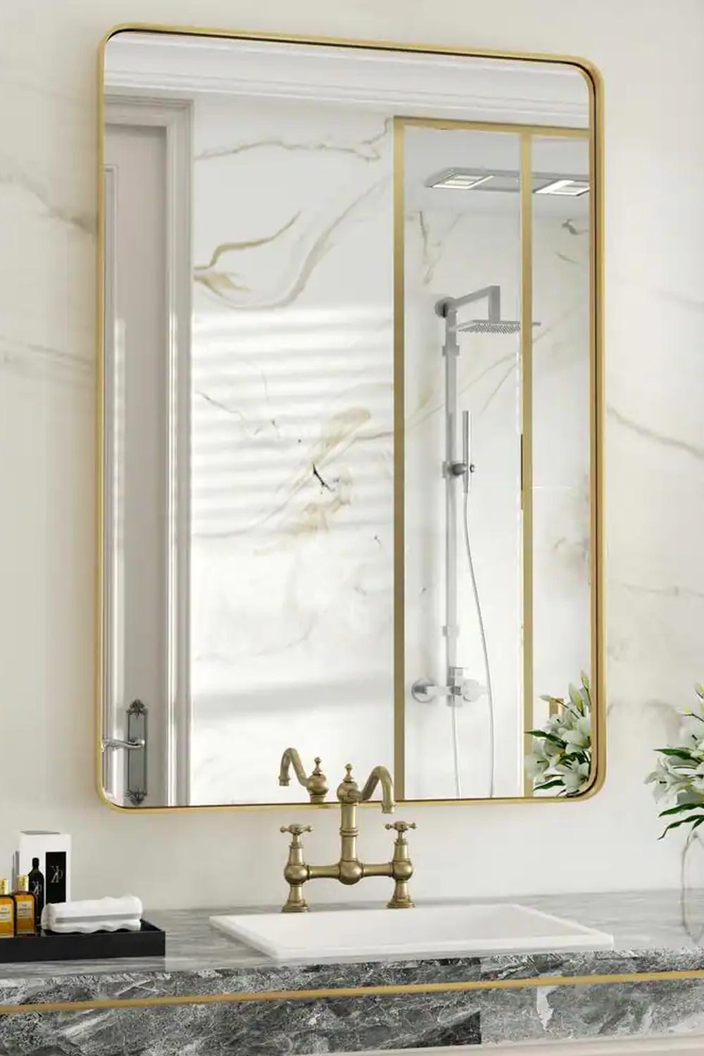 Bathroom showing a light-colored frame around a stylized mirror creating a soothing ambiance.