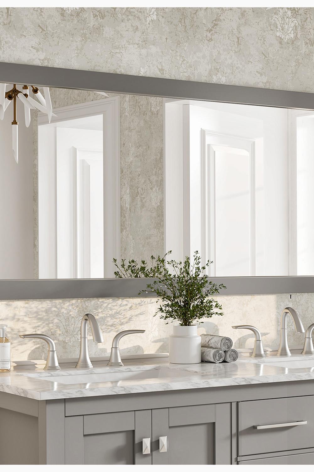Wide gray framed mirror showcasing artistic elements and contrasting features in a functional bathroom.