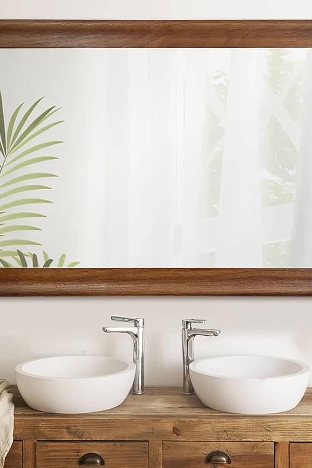 Stylish rustic bathroom featuring a wooden vanity and elegant mirror combination that adds a welcoming ambiance.