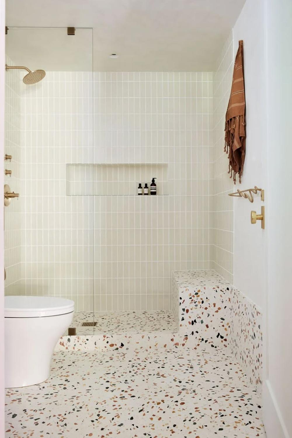 Modern bathroom featuring minimalist design with colorful terrazzo flooring