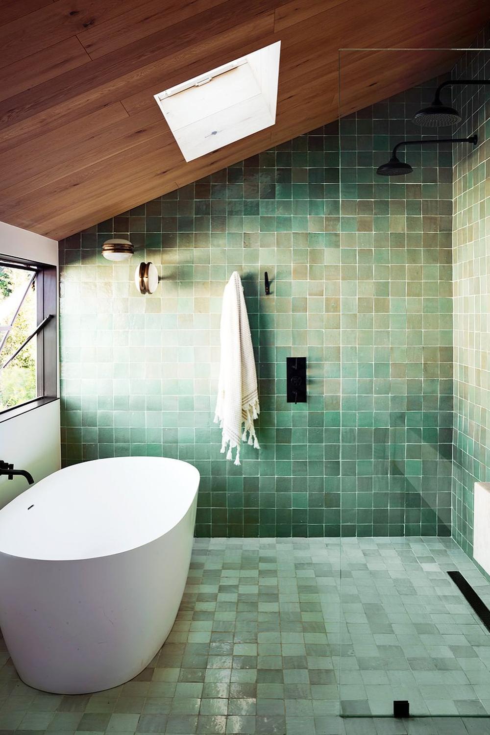 Modern bathroom design featuring natural-inspired green tiled walls