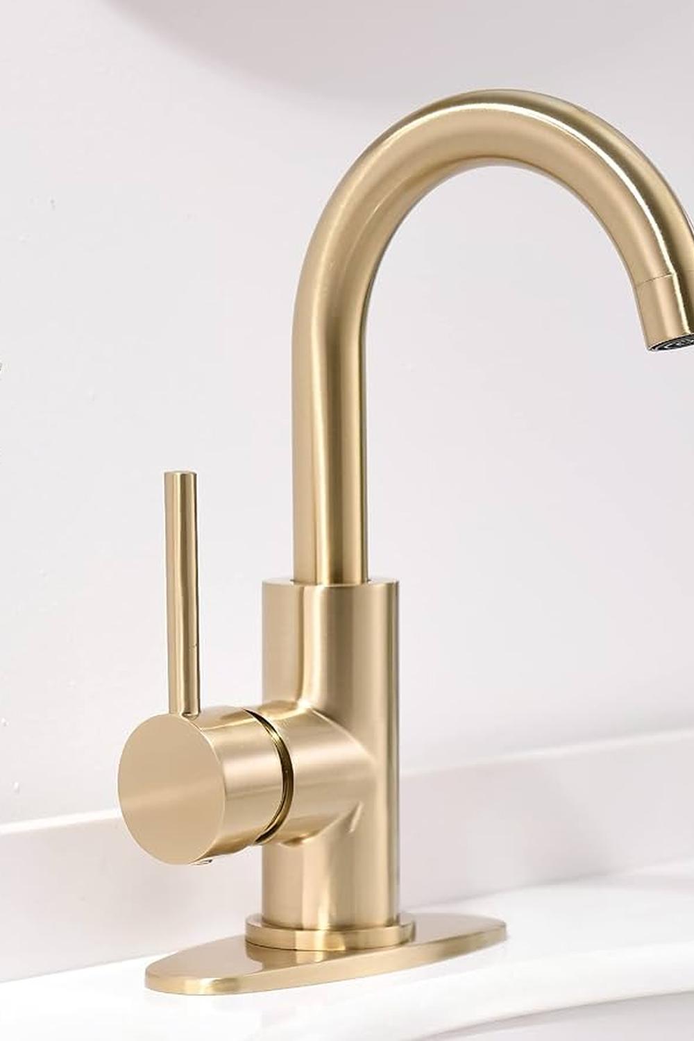 A modern gold faucet exhibiting a sleek design, perched gracefully on a white countertop.