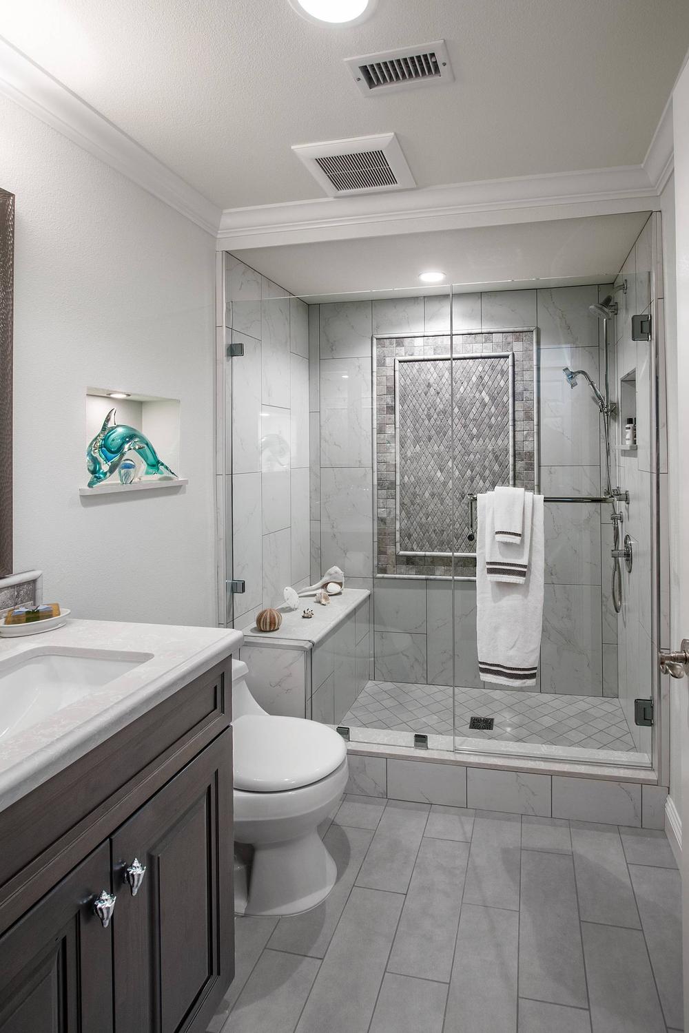 Baño minimalista con azulejos alargados en gris