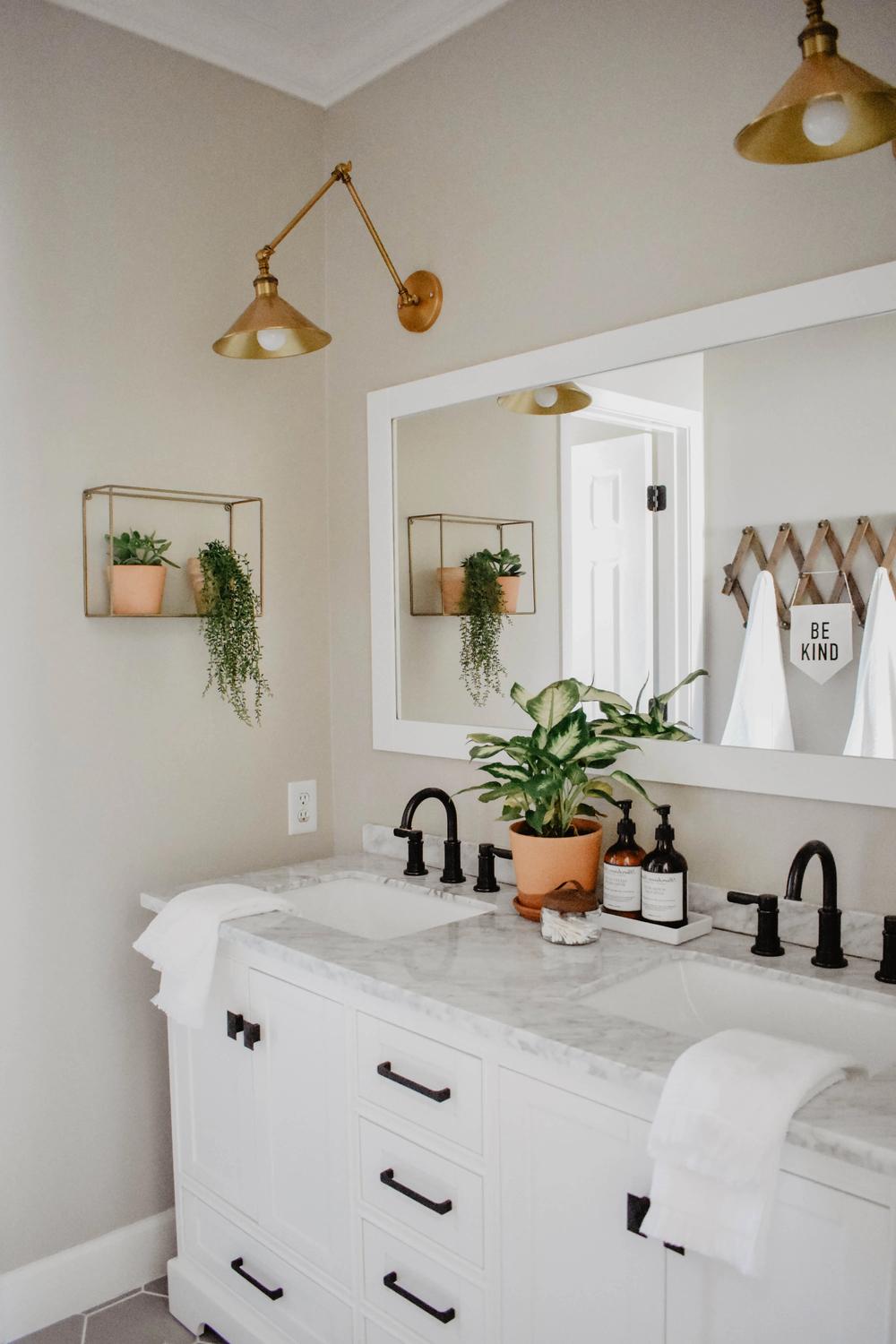 Baño boho encantador con toques de oro y madera