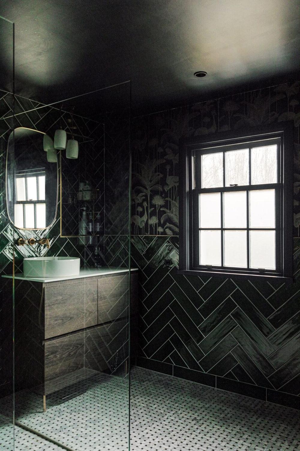 Luxurious bathroom showcasing a serene escape with deep green tones and modern fixtures.