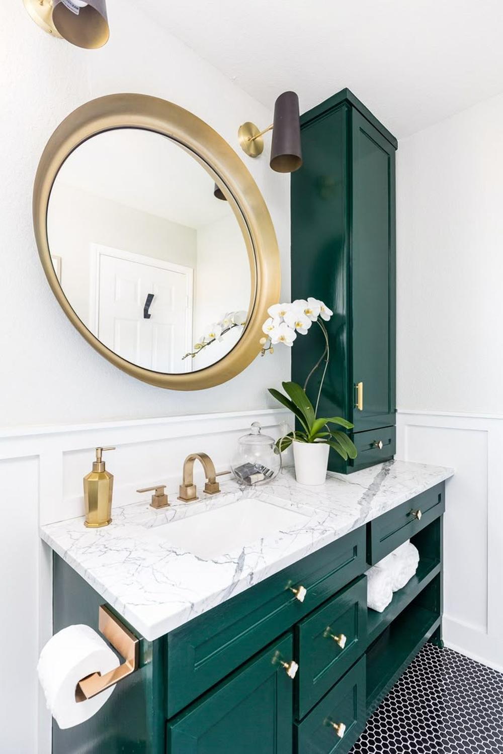 Stylish green and gold bathroom featuring modern design elements.