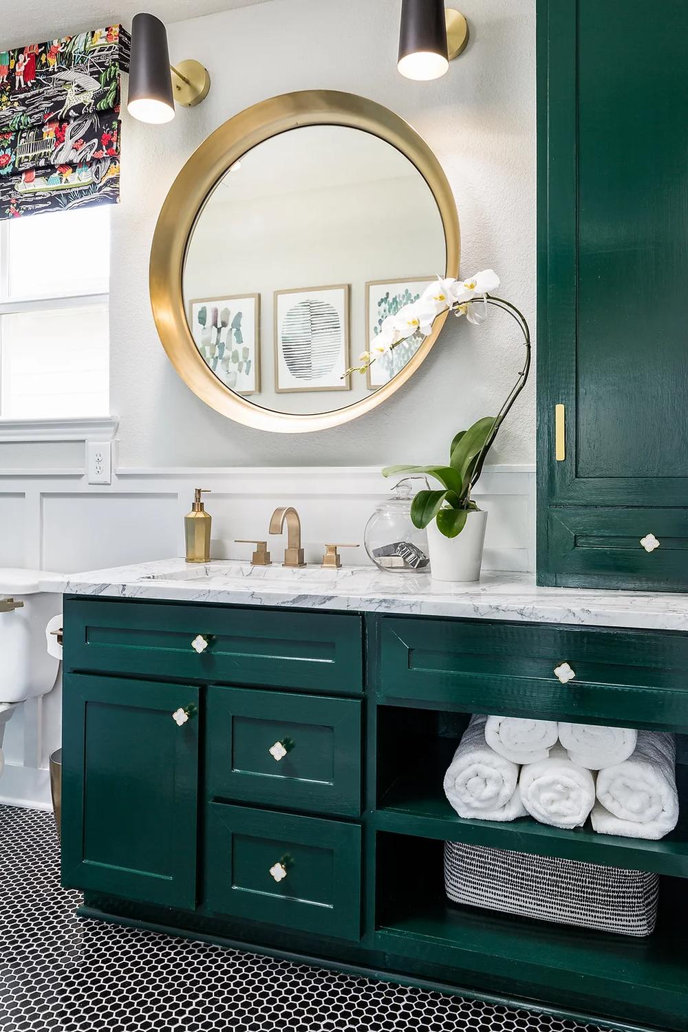 Stylish green bathroom featuring a unique vanity and elegant gold details.