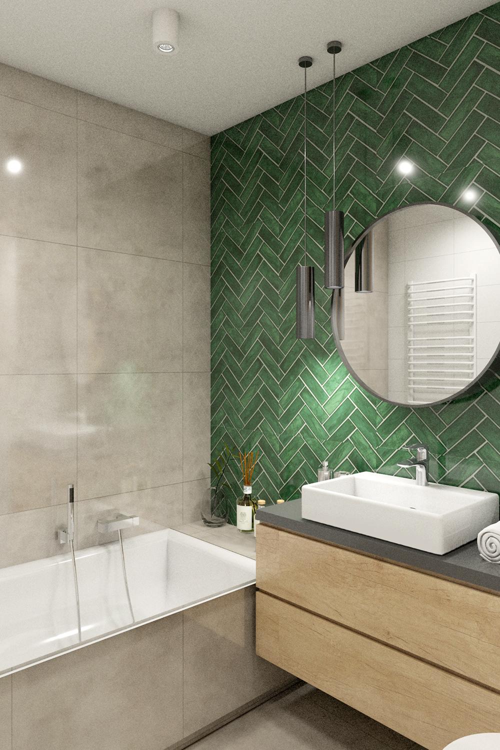 Baño con azulejos verde en sarga que destacan en la pared, con bañera y mueble de baño modernos.