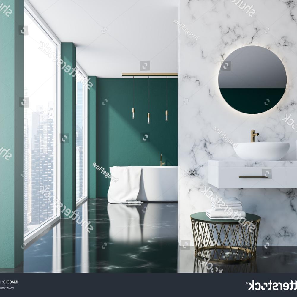 A contemporary bathroom showing a green marble design, large windows, and a freestanding bathtub.