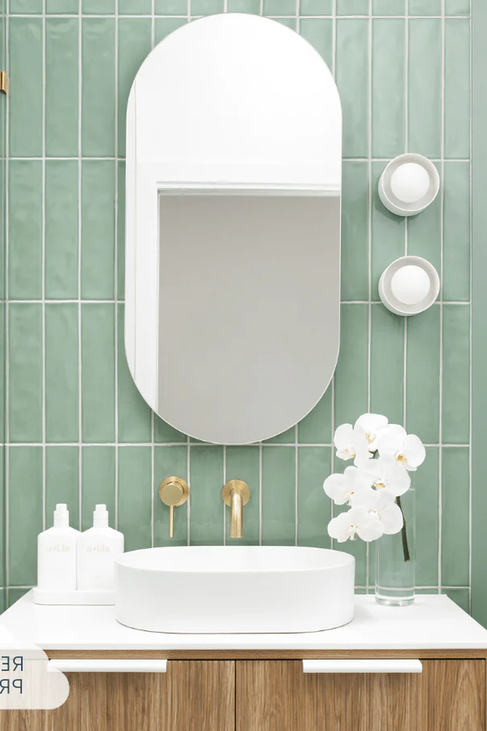 Elegant bathroom design featuring green subway tiles and refined decor.