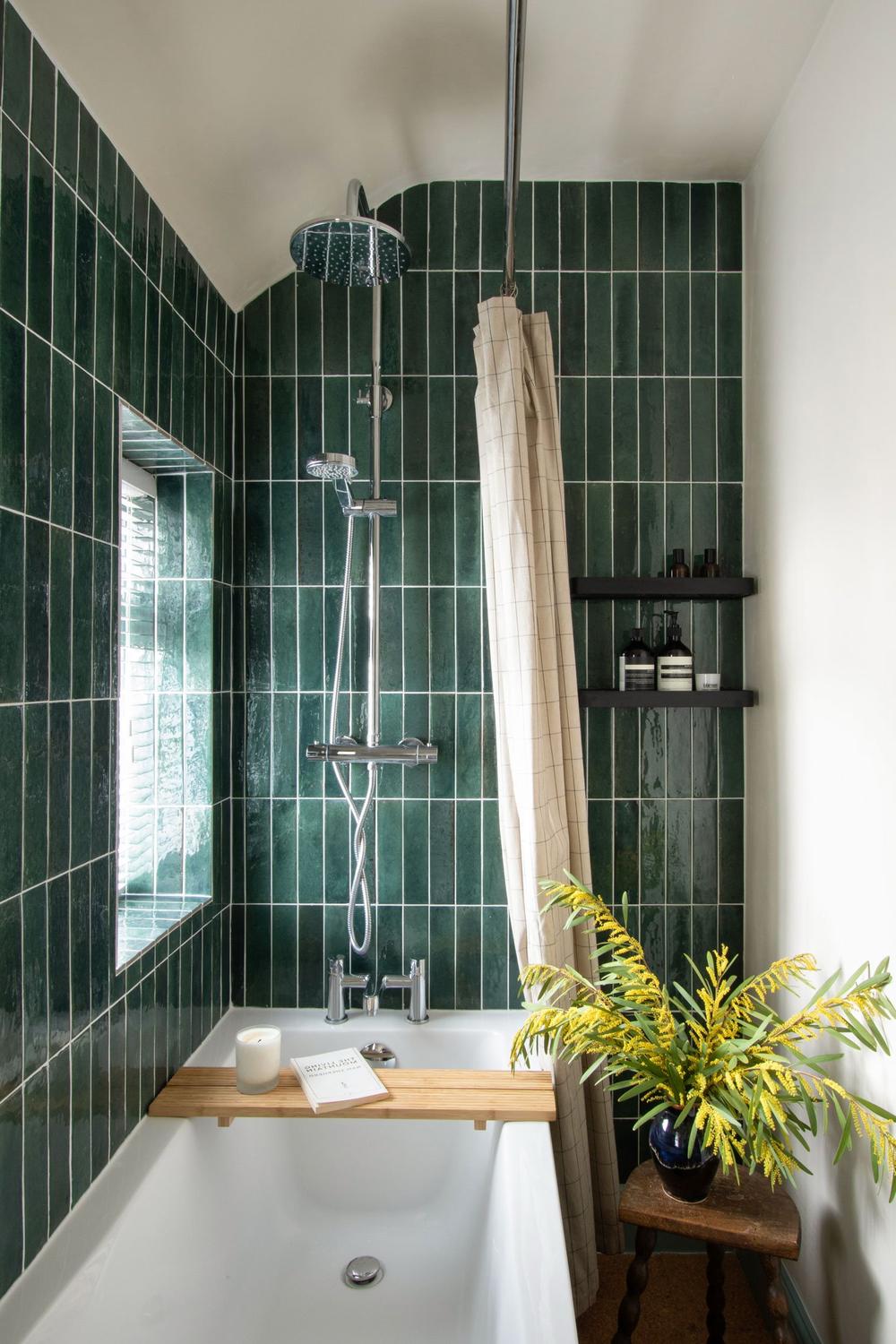 Contemporary modern bathroom featuring dark green vertical tiles and stylish fixtures.