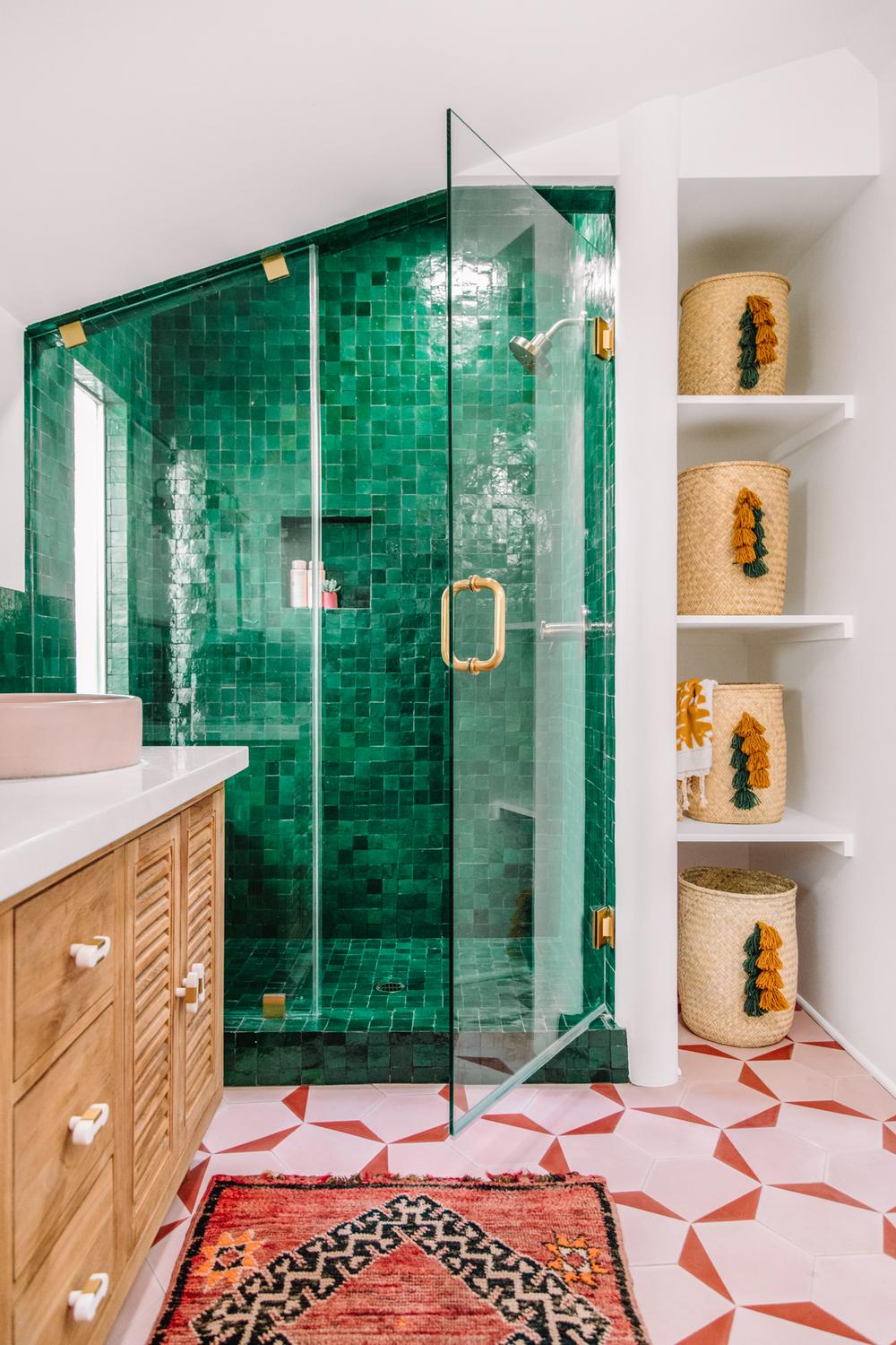 Bathroom exemplifying modern design with a striking blend of green tiles and warm accents.