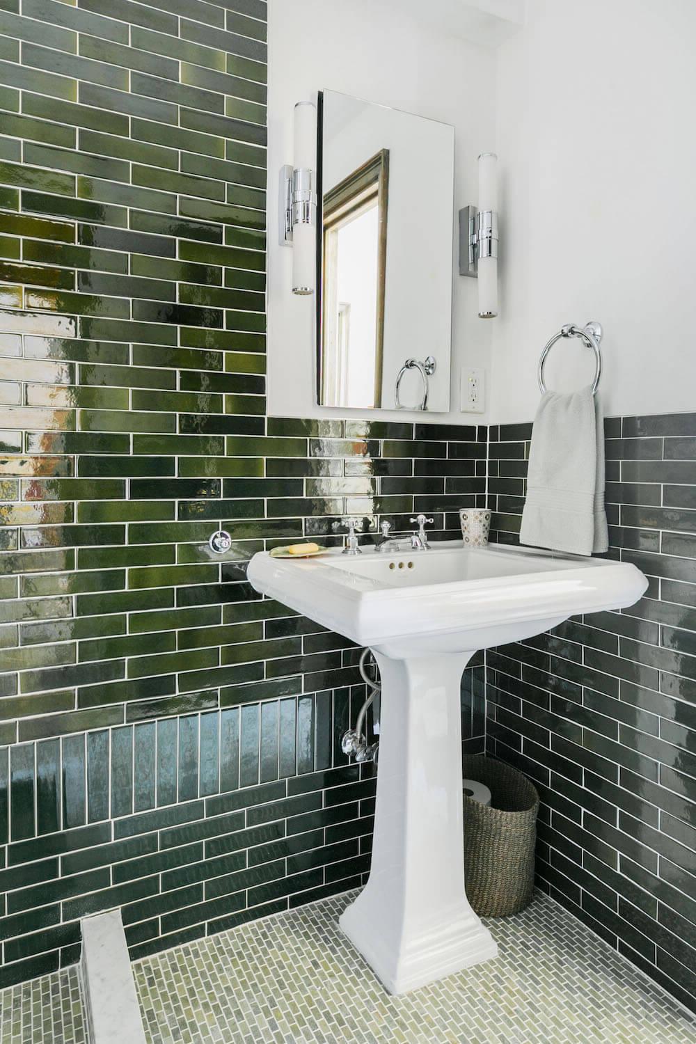 Modern bathroom design featuring a sleek green tile theme and bright accents.