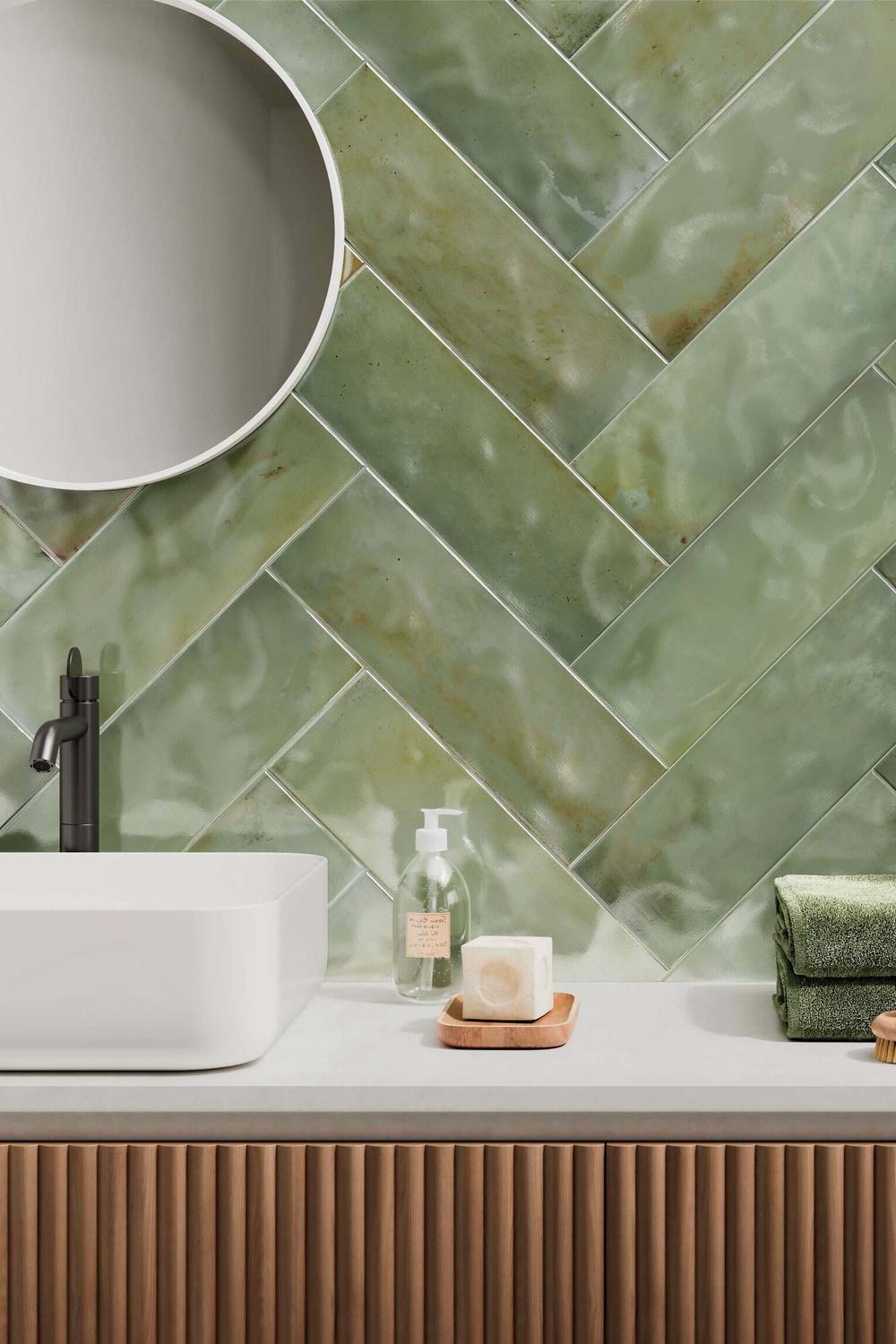 Baño con azulejos verde Zellige en patrón de espiga