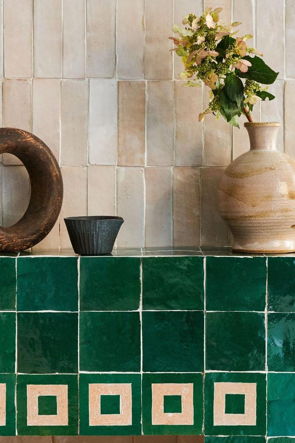 Elegant green zellige tile work with charming decor.