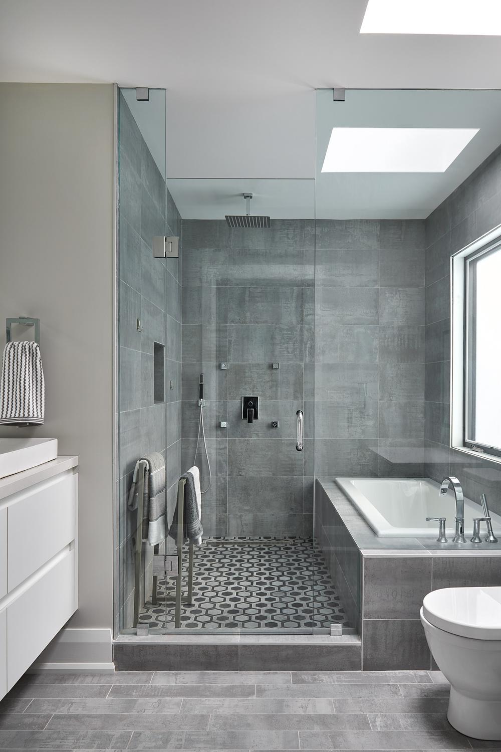 Modern grey tile bathroom featuring a calming color scheme with various shades of grey