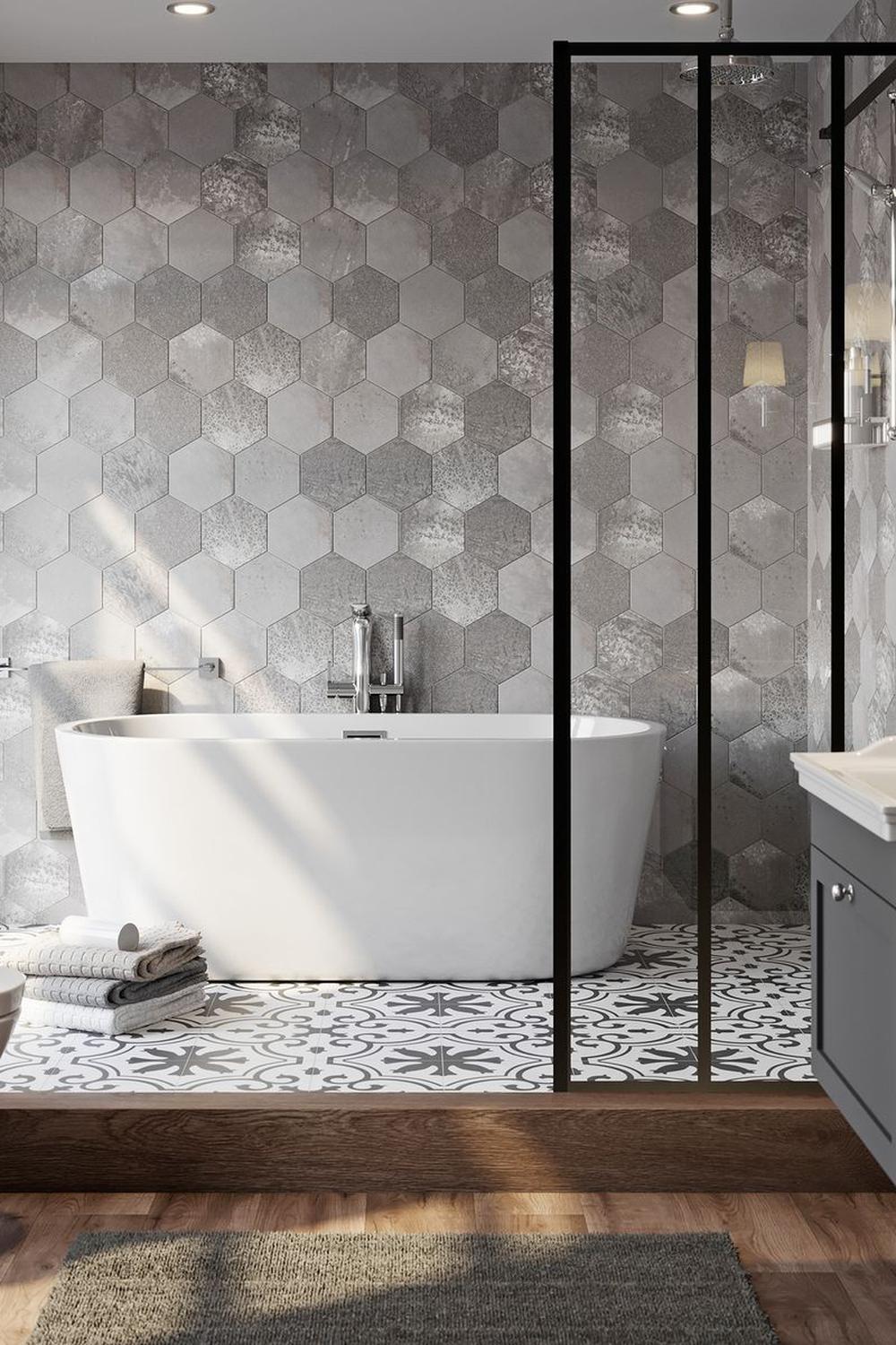 Natural light streaming through windows enhances the aesthetic in a grey tile bathroom