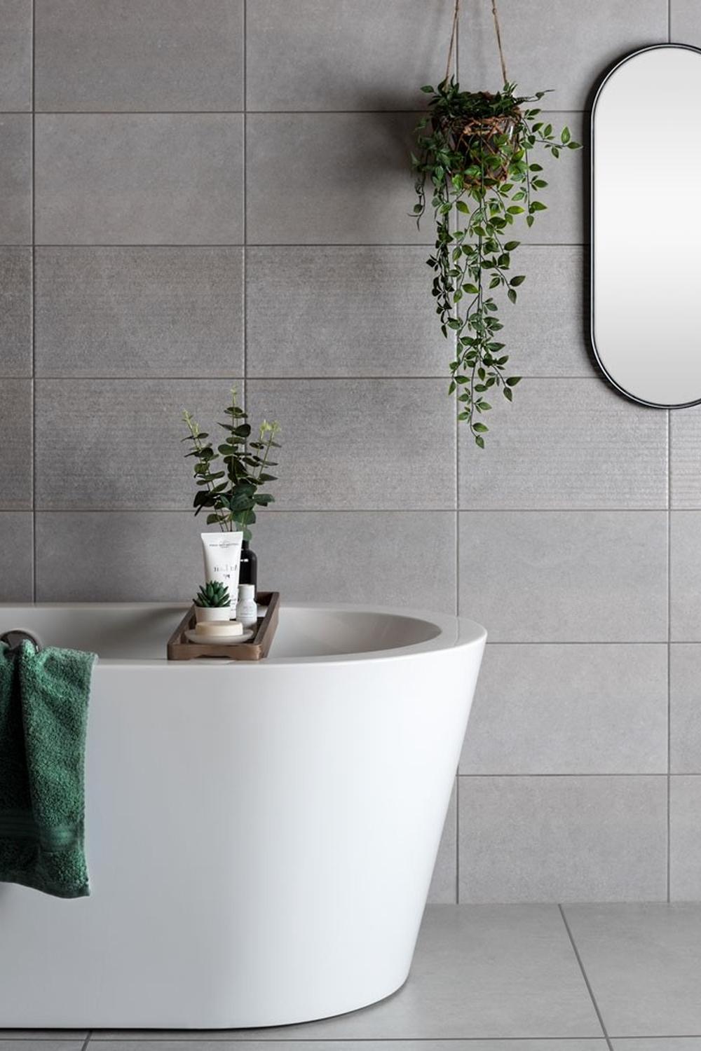 Customized fixtures add a unique touch in a grey tile bathroom
