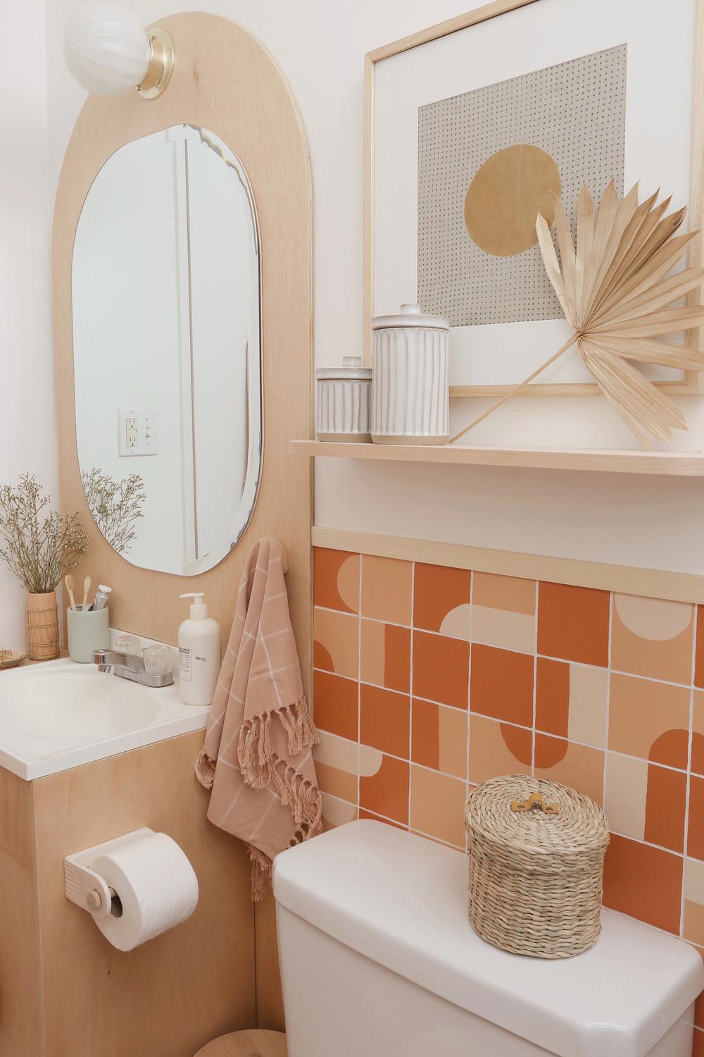 A stylish bathroom featuring colorful geometric tiles and modern wood accents