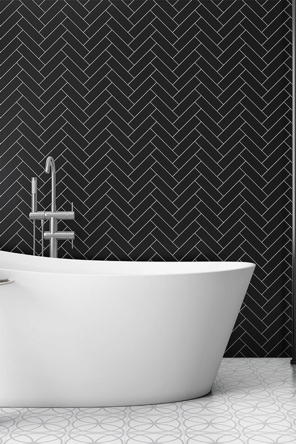Sleek modern bathroom featuring herringbone-patterned black tile wall.