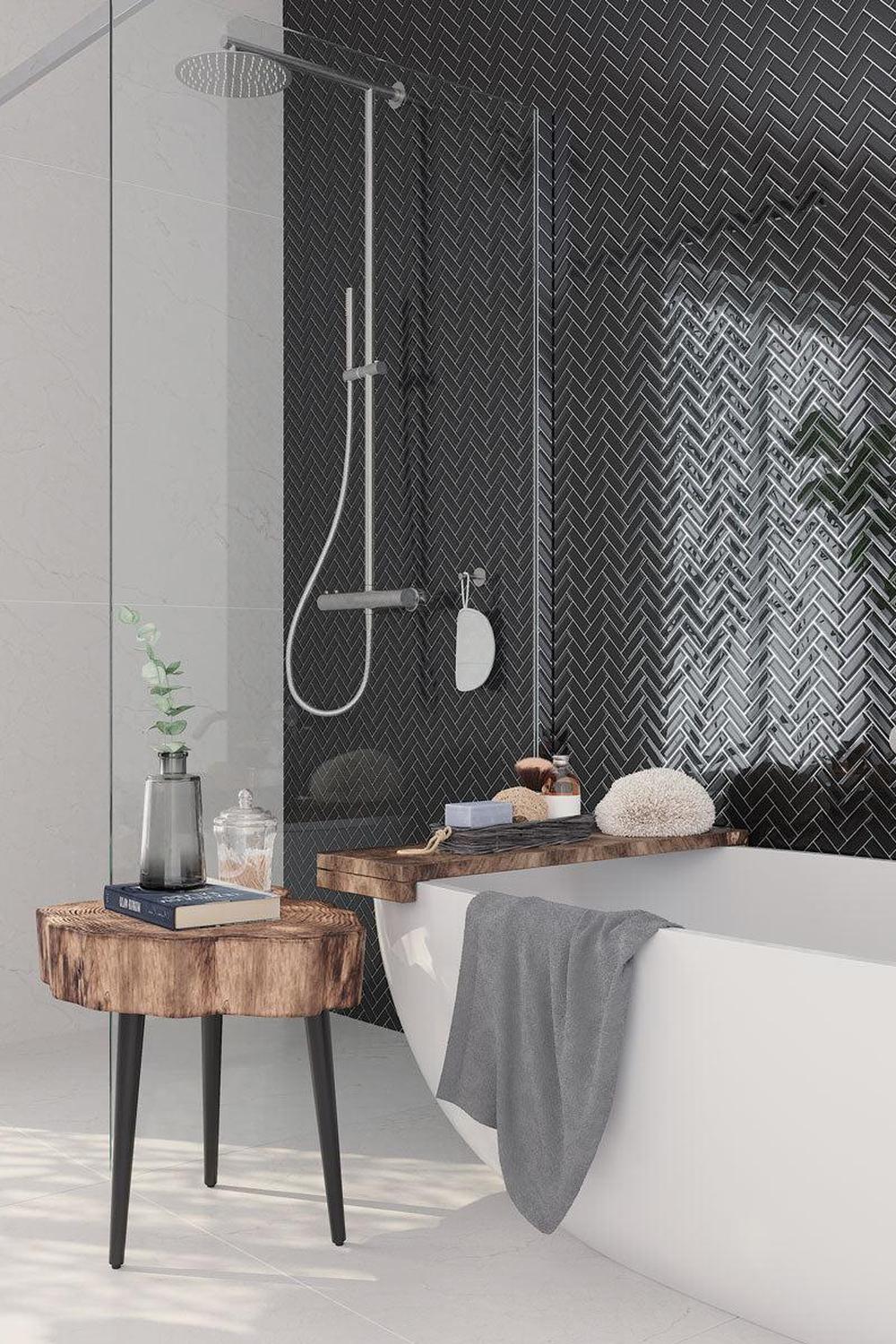 Stylish modern bathroom with herringbone-patterned black tiles.